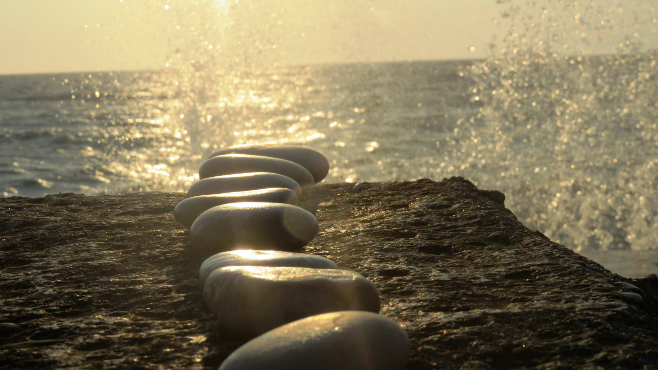 Stepping stones across water representing setting personal goals and making steady progress in health and diabetes management