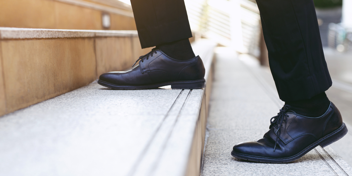 Person walking up steps, symbolizing taking small, practical steps toward managing and reversing type 2 diabetes