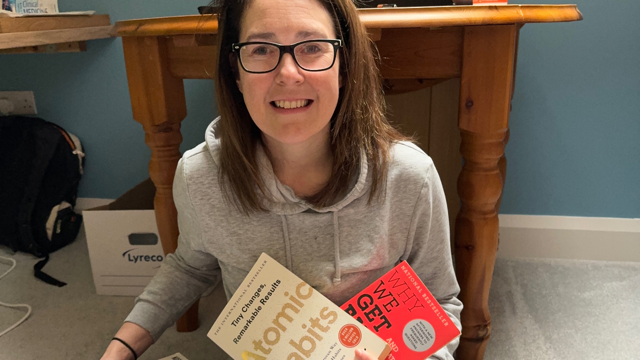 Dr Nerys holding books about reversing type 2 diabetes and weight management