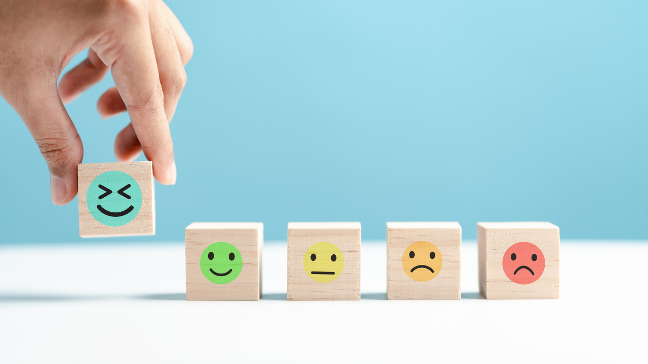 Dice with happy and sad faces showing emotional stress impacting cortisol and type 2 diabetes risk