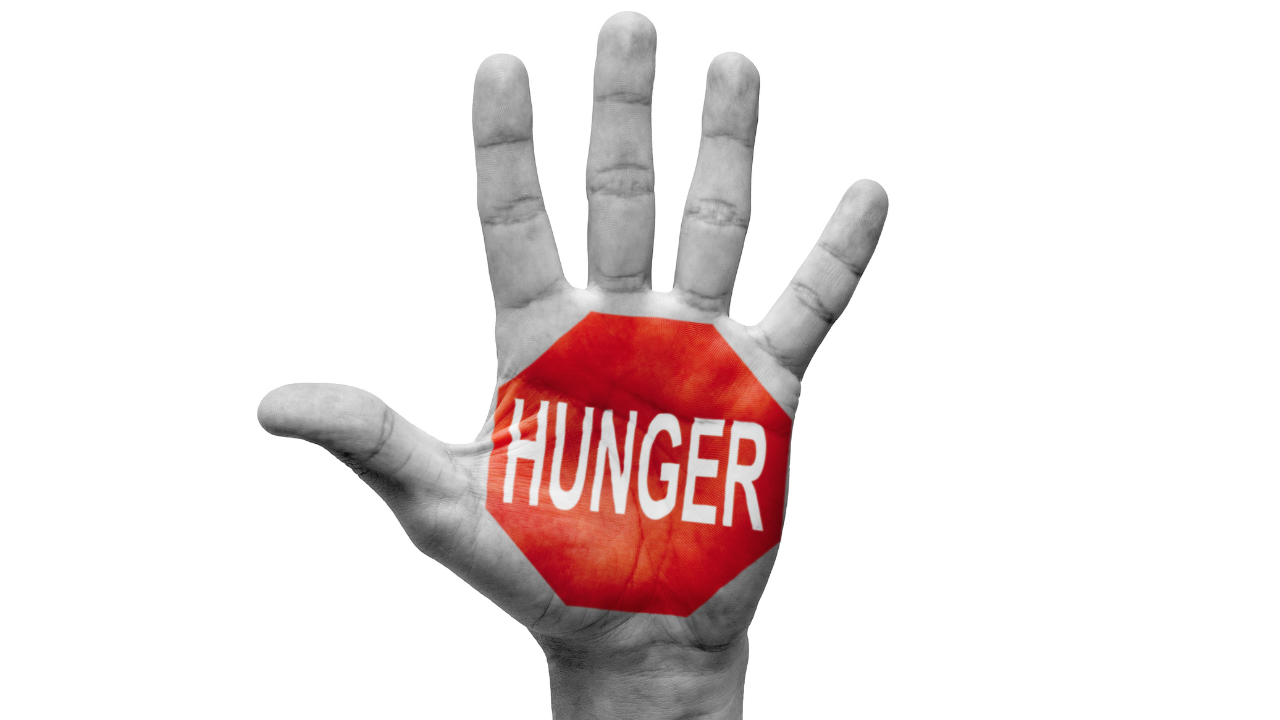 Hand with the word "hunger" painted on, symbolizing awareness of different types of hunger
