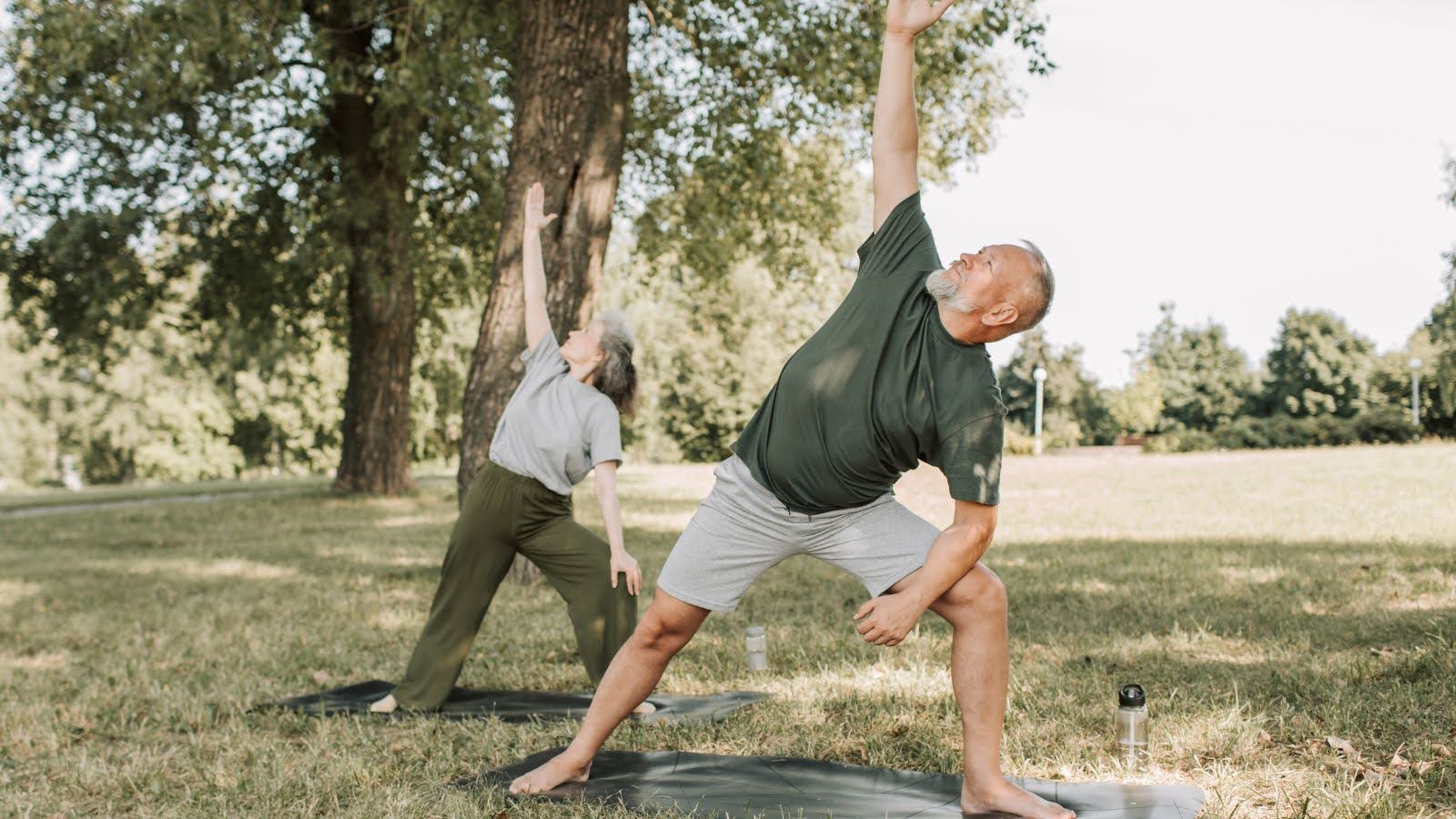 Two people exercising and stretching outdoors to improve fitness and insulin sensitivity for reversing type 2 diabetes after 50