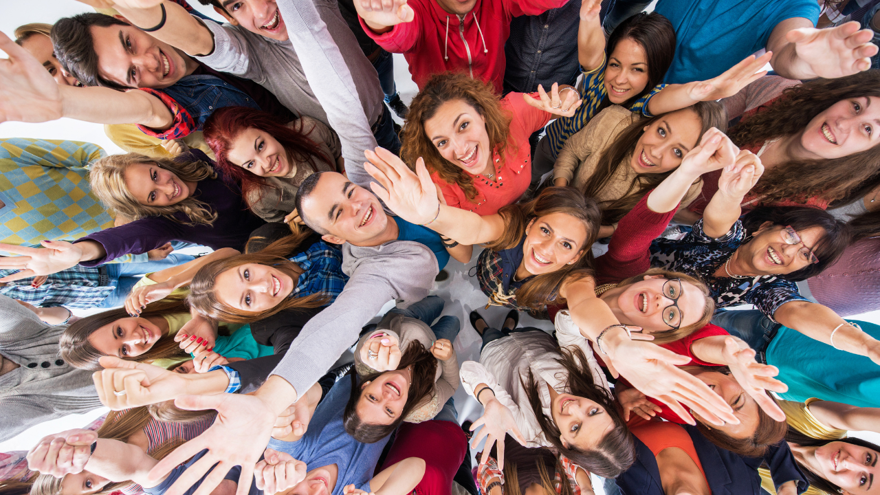 A group of people in a huddle raising their arms to celebrate health achievements and support reversing type 2 diabetes
