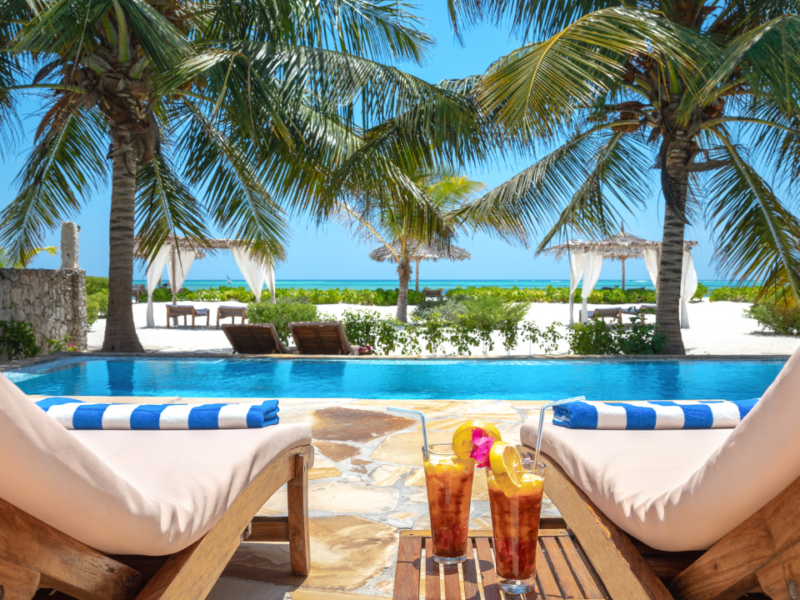 Sunloungers by a pool symbolising a relaxing low-carb holiday while learning how to reverse type 2 diabetes
