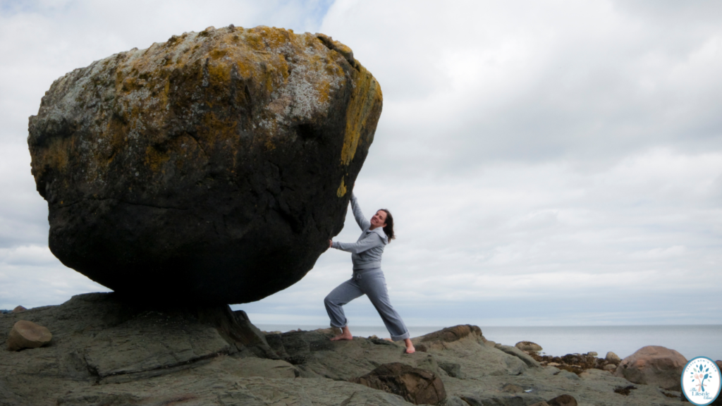 Woman holding a large rock symbolizing strength and willpower for reversing type 2 diabetes