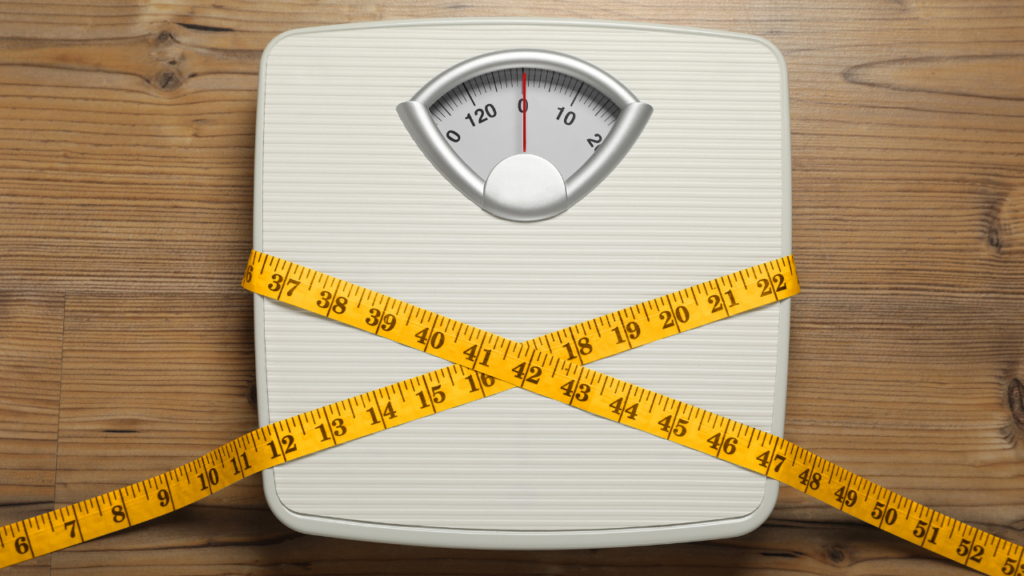 Scales and a measuring tape showing weight management as part of reversing type 2 diabetes